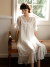 Woman wearing SlesSic sheer long sleep dress near window in elegant bedroom