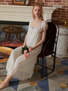 Elegant white vintage nightgown styled beside fireplace with romantic details