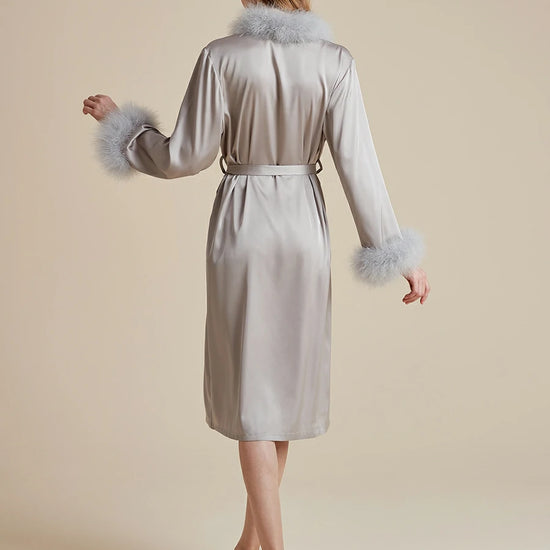 Back view of silver satin wrap robe with feather cuffs