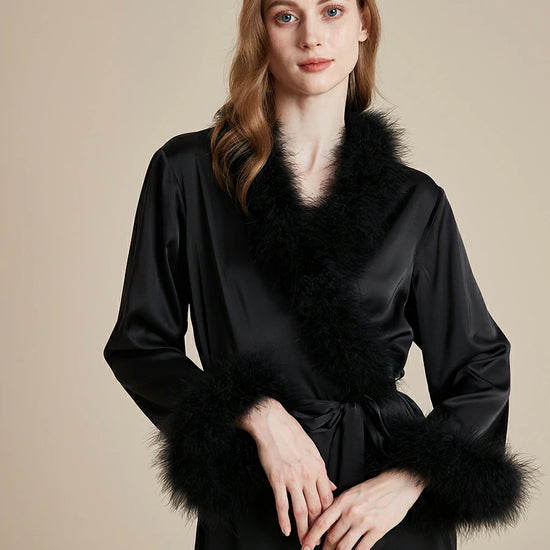 Close up of black satin feather trim luxury robe