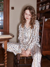 Close-up of women's silky printed pajama set with relaxed lounge styling