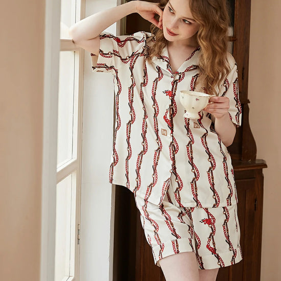 Feminine satin pajama shorts set with sophisticated vintage chain detailing