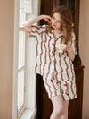 Feminine satin pajama shorts set with sophisticated vintage chain detailing