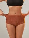 Woman stretching seamless high-waist leakproof period panties in brown