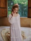 Elegant blush pink lounge dress beside bedroom window