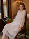 Woman wearing blush pink romantic lace nightgown indoors