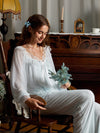 Light blue sheer lace pajama set shown from the front with ribbon bow and ruffled shoulders