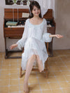 Light blue vintage princess nightgown styled beside wooden piano in cozy room