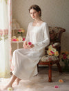 Woman sitting in romantic white cotton nightgown