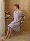 Woman sitting in lavender vintage sleep dress
