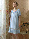Elegant blue cotton lace trim nightgown by window