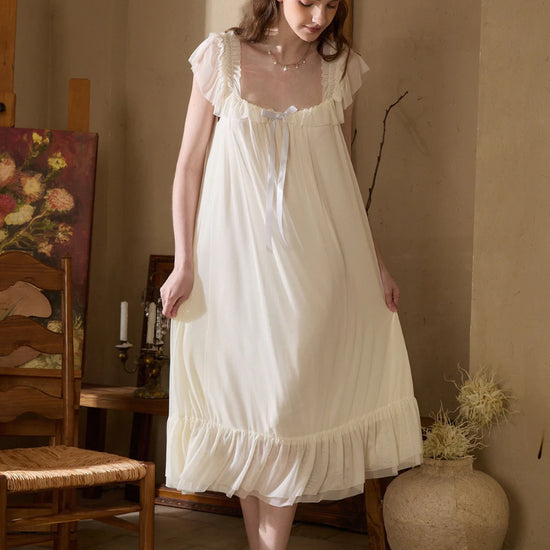 Slessic elegant ivory nightgown with sheer ruffle sleeves and flowing silhouette in warm vintage interior