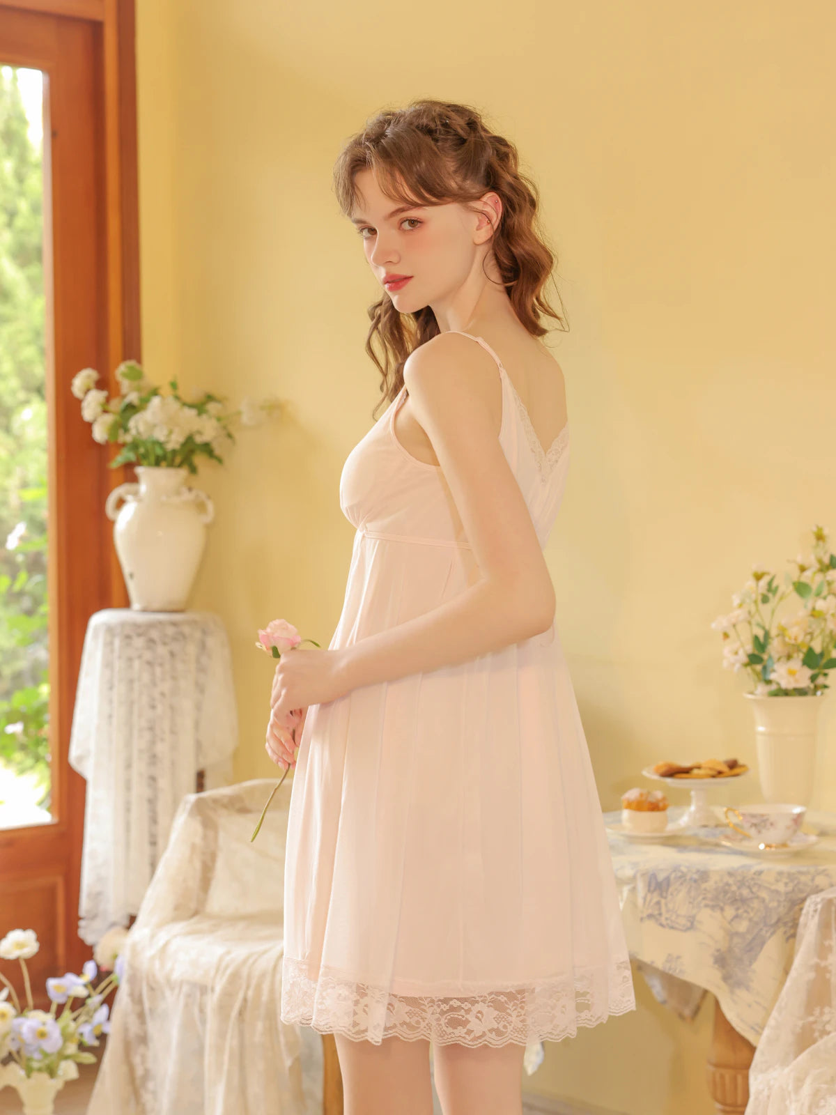 Side view light pink cami nightdress with delicate lace trim and airy skirt