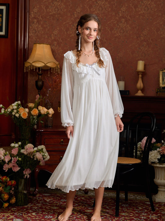 White sheer lace long sleeve nightgown shown in a full front view with a flowing tiered hem