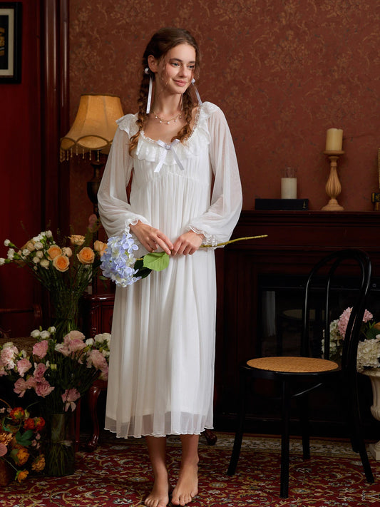White romantic nightgown styled beside flowers, highlighting the square lace neckline and long silhouette