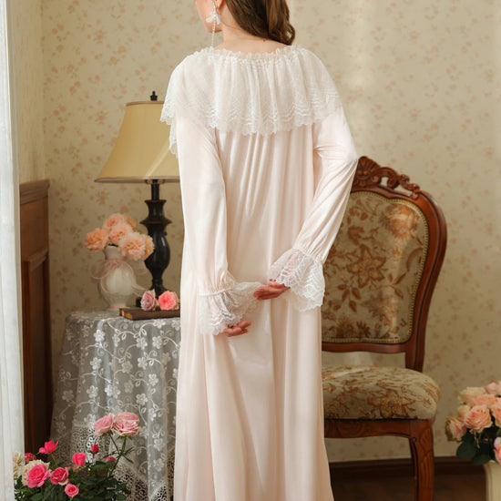 Back view of the light pink nightgown showing the scalloped lace cape collar, long sleeves, and softly gathered hem