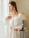 Closer front view of the white nightgown showing the layered lace cape collar, white ribbon bow, and flared lace cuffs