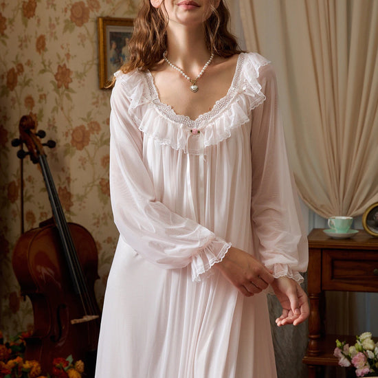 Light pink mesh nightgown front view showing the ruffled lace neckline, small rose bow, and sheer gathered sleeves