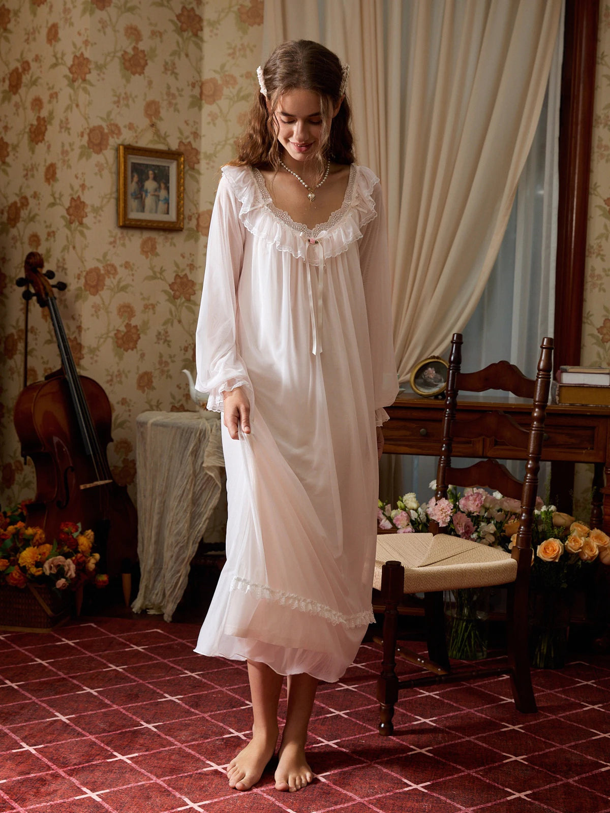 Standing angled view of the light pink nightgown showing its flowing mesh skirt and softly ruffled cuffs