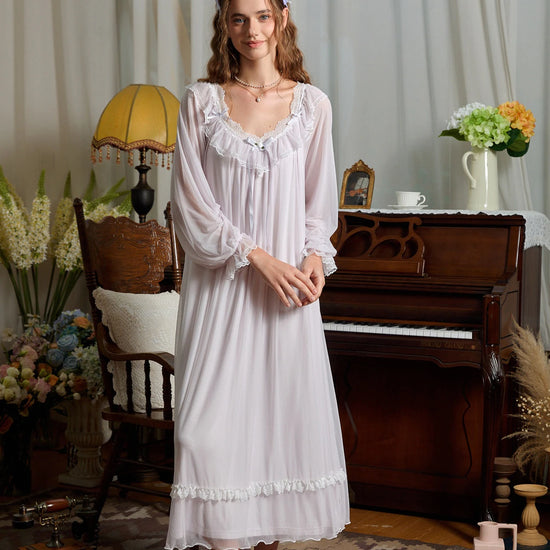 Full front view of the light purple mesh nightgown with a rose bow, long sheer sleeves, and lace-trimmed skirt