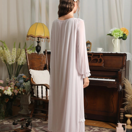 Back view of the light purple nightgown showing the gathered back neckline, loose mesh drape, and long ruffled sleeves
