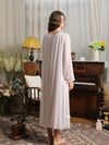 Back view of the light purple nightgown showing the gathered back neckline, loose mesh drape, and long ruffled sleeves
