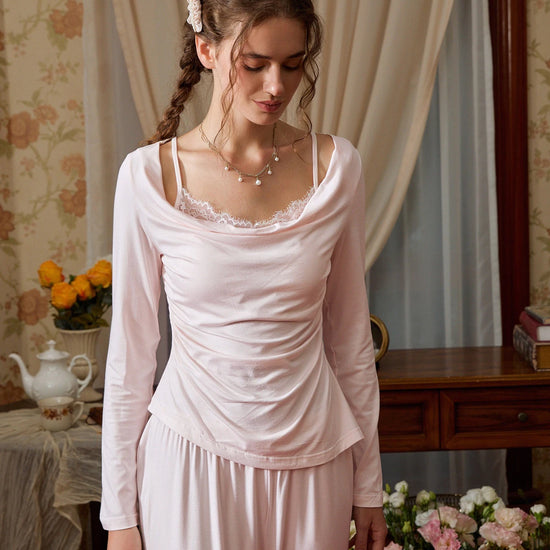 Light pink pajama set shown from the front with a lace camisole-effect neckline and soft drape