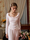 Light pink pajama set shown from the front with a lace camisole-effect neckline and soft drape