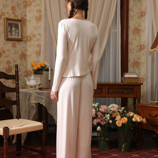 Back view of the light pink pajama set showing the relaxed top and full-length wide-leg pants