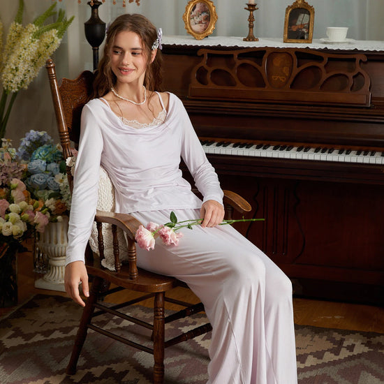Seated view of the light purple pajama set with a draped neckline and flowing pants