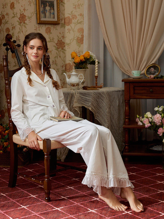 White cotton-blend pajama set styled seated to show the lace collar and relaxed fit