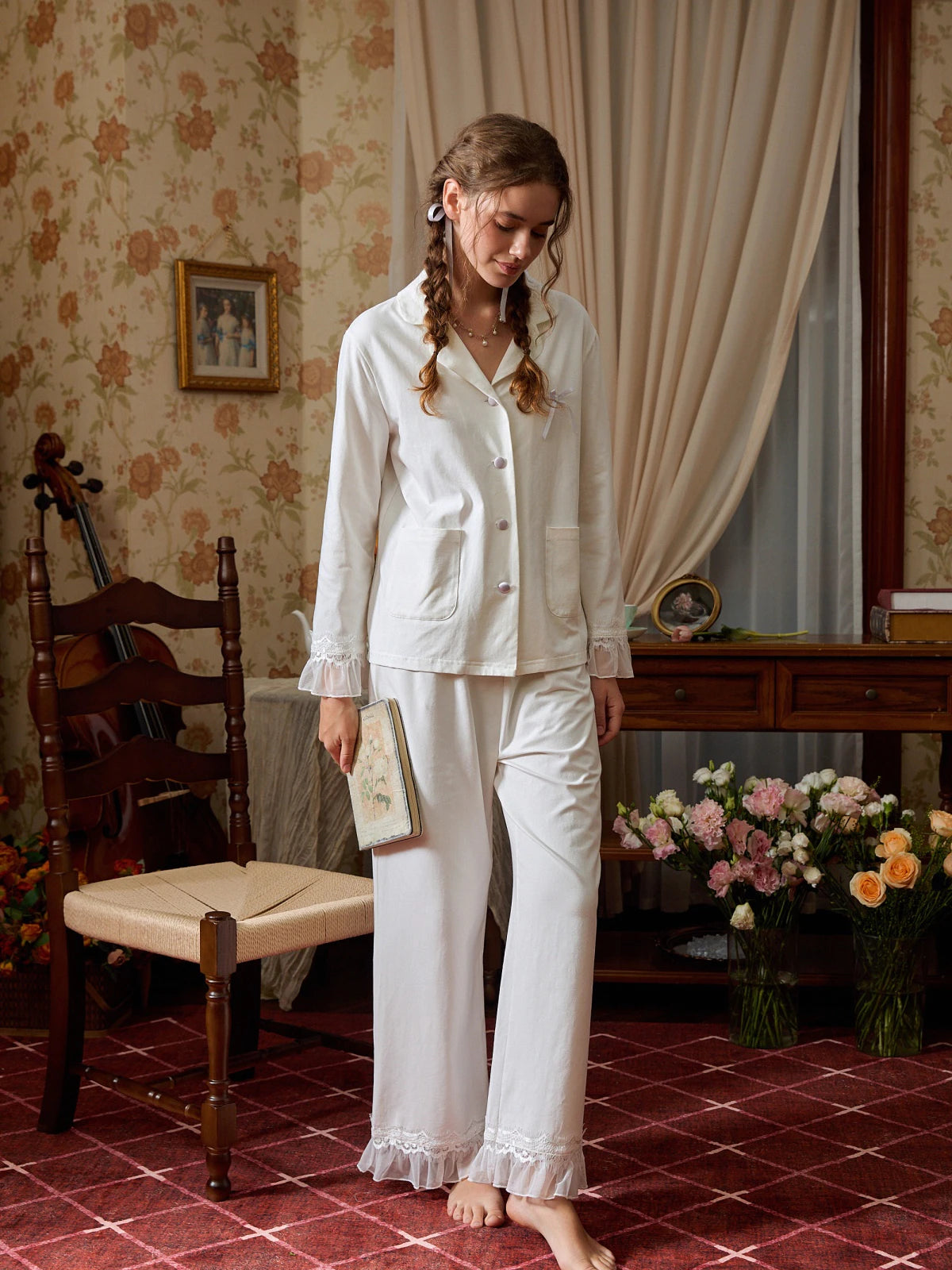 Closer view of the white button-down pajama top with covered buttons, bow, and patch pockets
