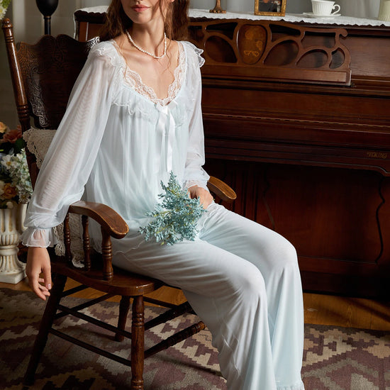 Seated light blue pajama set view highlighting floral mesh sleeves and relaxed pants