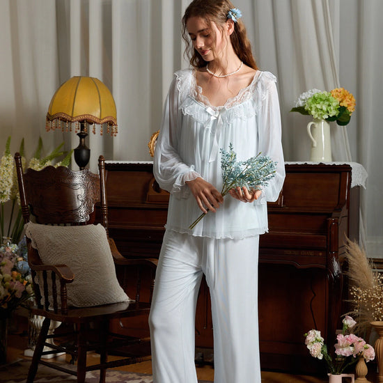 Full-length light blue pajama set styled to show its gathered cuffs and lace-trimmed pant hems