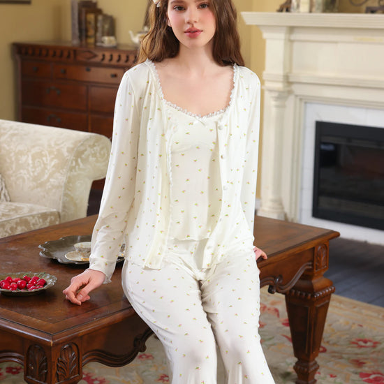 White three-piece floral pajama set shown with button cardigan, camisole, and full-length pants