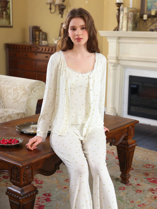 White three-piece floral pajama set shown with button cardigan, camisole, and full-length pants