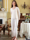 Seated light pink floral pajama set view highlighting the lace-edged neckline and rose print