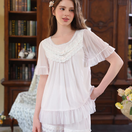 Light pink lace ruffle short pajama set shown from the front with flutter sleeves and shorts