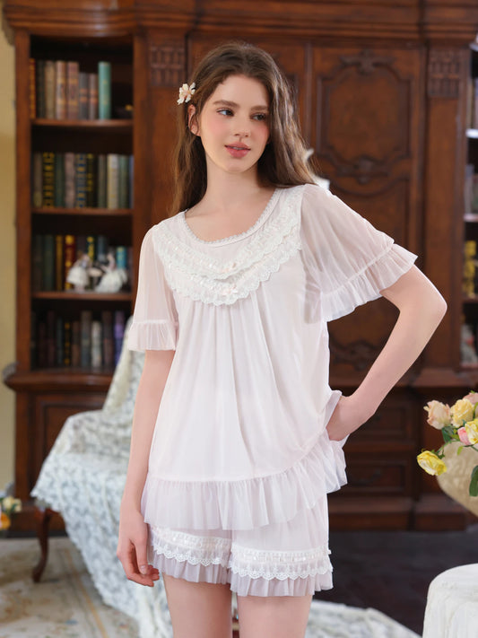 Light pink lace ruffle short pajama set shown from the front with flutter sleeves and shorts