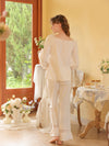 Full-length white pajama set view showing gathered sleeves and ruffled pant hems
