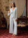 Light blue viscose pajama set shown full length with the cardigan tied at the front and flared lace cuffs