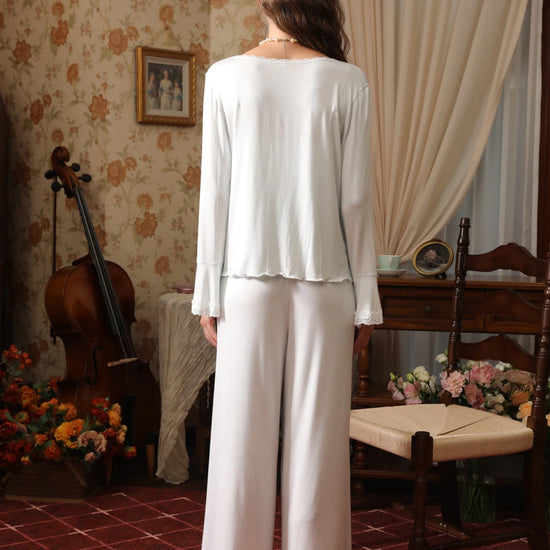 Back view of the light blue cardigan pajama set showing the relaxed drape, long sleeves, and lace-trimmed pant hems
