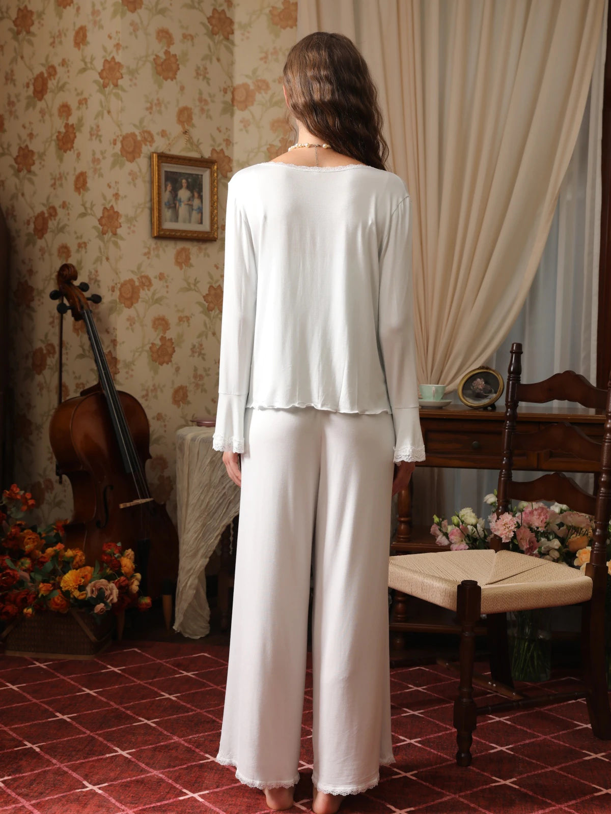 Back view of the light blue cardigan pajama set showing the relaxed drape, long sleeves, and lace-trimmed pant hems