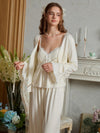 Closer front view of the light yellow pajama set highlighting the cardigan tie, flared lace cuffs, and gathered cami