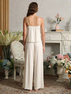 Back view of the light yellow cami pajama set showing adjustable shoulder straps, a gathered back, and wide-leg pants