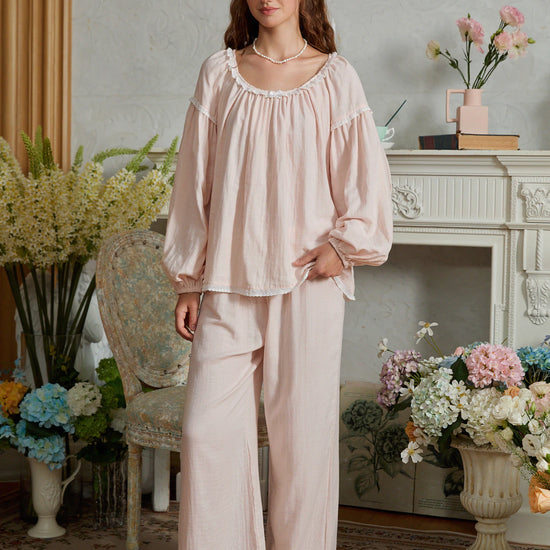 Full-length front view of the light pink cotton pajama set with a loose gathered top and lace-trimmed wide-leg pants
