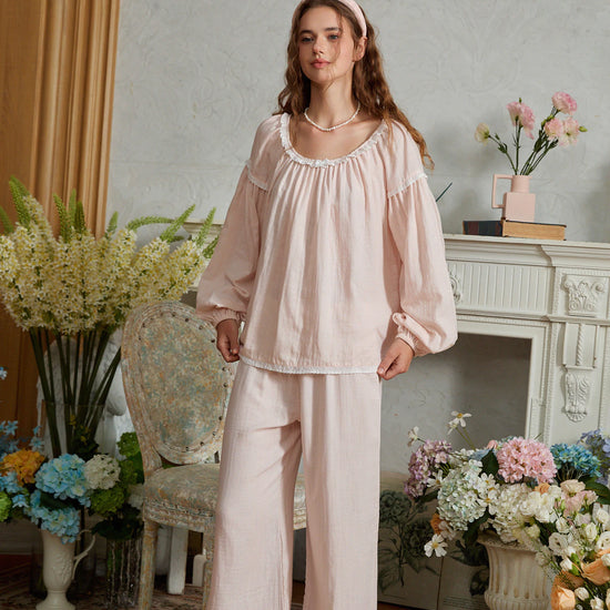 Light pink cotton pajama set shown full length with the top hem held out to show its relaxed gathered shape
