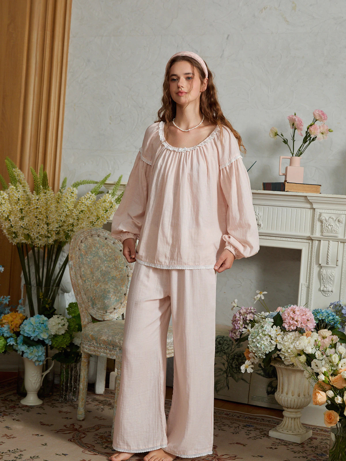 Light pink cotton pajama set shown full length with the top hem held out to show its relaxed gathered shape