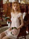 Woman lounging in SlesSic romantic lace sleepwear with vintage home aesthetic